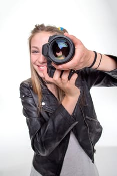 Teenage girl taking a photo with a camera