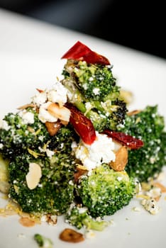 close up shot of broccoli salad with feta cheese