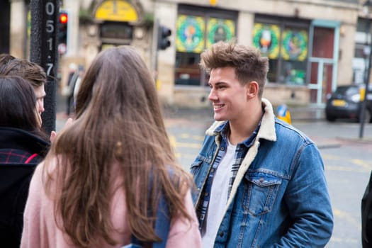 Group of young adults talking in the city.
