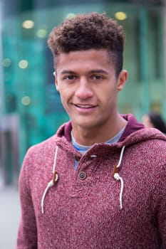 Portrait of an attractive, young, mixed-race man in the city