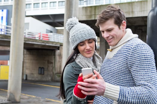 Young couple taking a selfie on a smartphone in the city