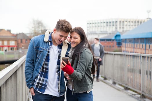 Young couple taking a selfie on a smartphone in the city