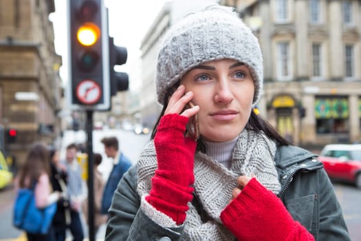 Close up of a young woman on the phone in the city