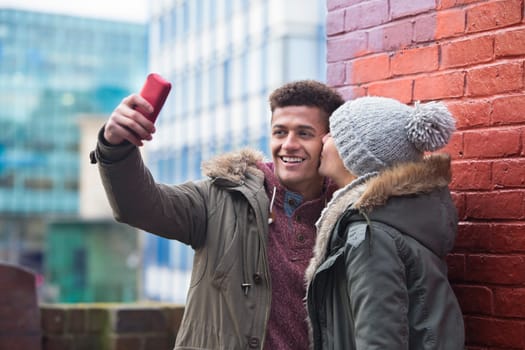 Young couple taking a selfie in the city.