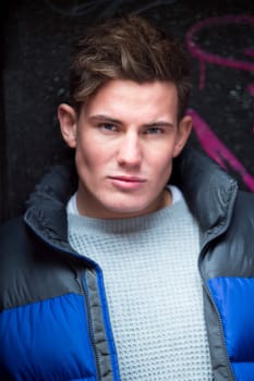 Portrait of an attractive, young man against an urban background in the city