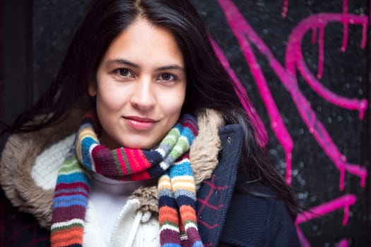 Portrait of an attractive, young, woman against an urban background in the city