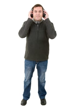 Young man listening to music, full length, isolated