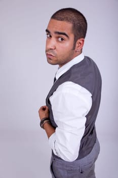young business man pensive, on a grey background
