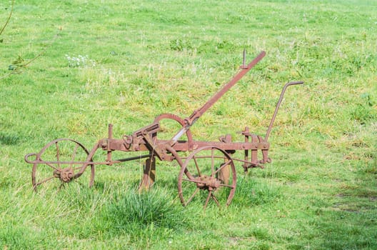 Old historical rusted plough on a farm in Germany.
