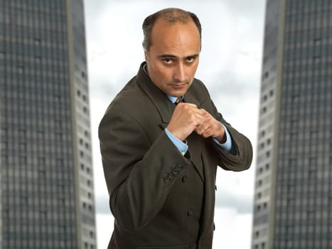 mature business man portrait with two buildings on the back