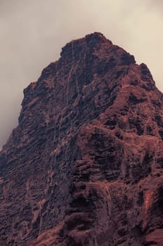 Dramatic mountains sinking in dusk clouds in red planet Mars