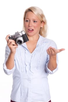 Young woman with analog camera looks skeptical