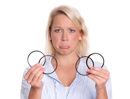 Photographer holds a few Uv filters and pulls a snout
