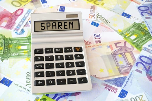 The word saving on display from calculator on Euro money notes