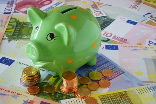 Piggy bank,euro banknotes and coins on finance