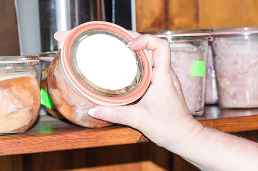 Self-slaughtered. Sausage in a mason jar. In a row on the shelf.