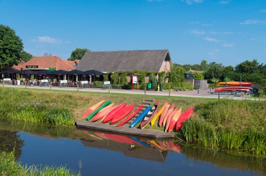 colorful canoes waiting along a canal for tourists