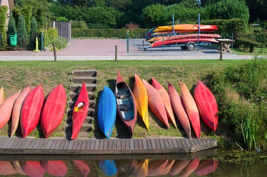 colorful canoes waiting along a canal for tourists