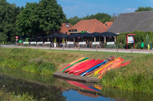colorful canoes waiting along a canal for tourists