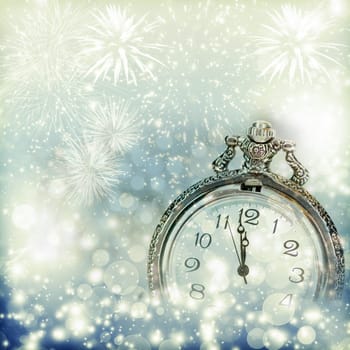 New Year's at midnight - Old clock with fireworks and holiday lights