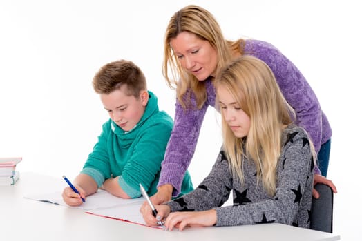 girl and boy learning together with teacher in the classroom