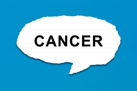 cancer with white paper tears on blue texture background