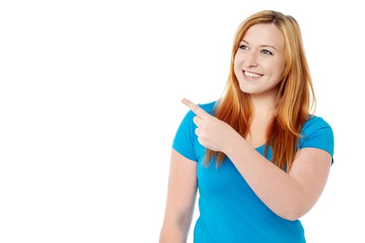 Young lady pointing towards copy space area