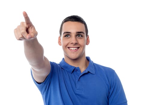 Young guy pointing towards copy space area