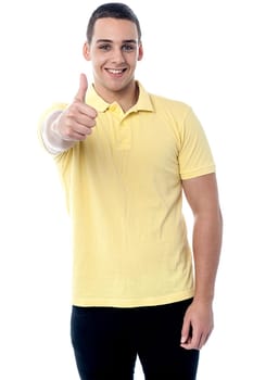 Boy showing thumbs up sign to the camera