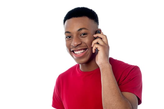 Cheerful boy talking on mobile phone