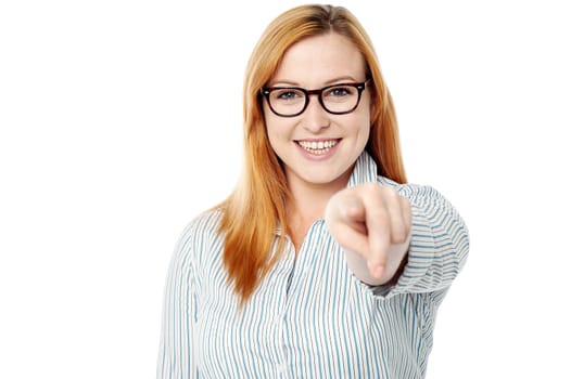Young woman pointing towards the camera