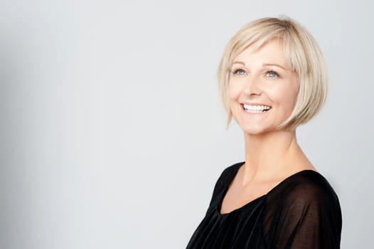 Smiling woman isolated on grey background