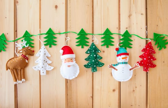 Garland with fir trees and Christmas decorations made of felt