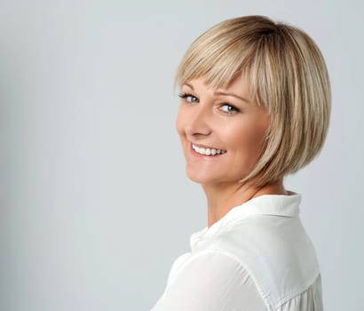 Smiling middle aged lady looking over shoulder