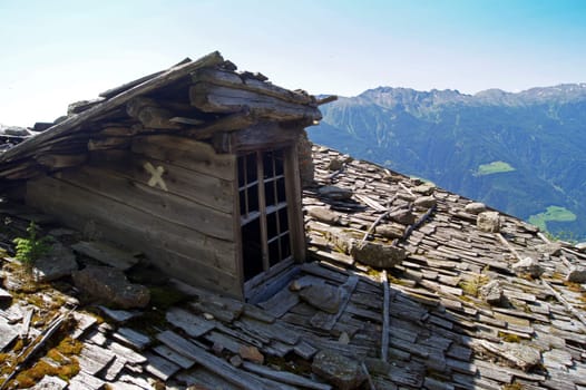 Old roof with wooden shingles at old alpine pasture in South Tyrol,Italy