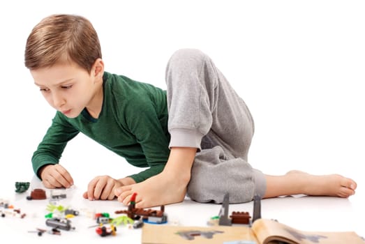 Handsome guy who is playing and building something from book