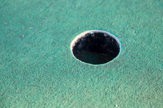 Miniature Golf Course Cup Close up.