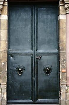 Mainz,Germany – September 04,2015: The heavy iron door of the entrance to Mainz Cathedral with engraved Latin words on September 4,2015 in Mainz.