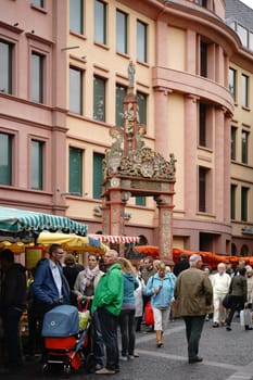 Mainz,Germany – September 04,2015: The stalls of the weekly market in Mainz with visitors on the market square at marktbrunnen on September 4,2015 in Mainz.
