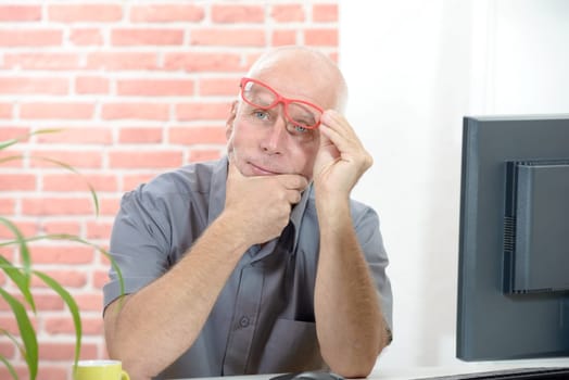 A businessman portrait senior pensive with red glasses