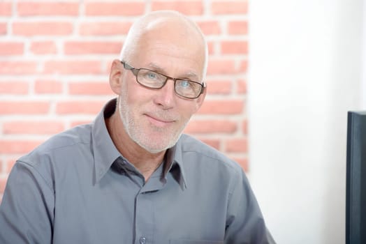 A businessman portrait senior sitting with glasses