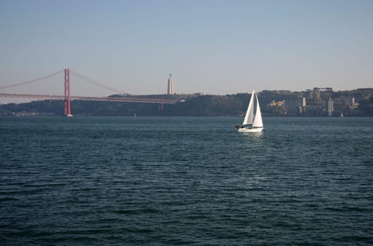 Sailing on the river Tagus with the 25 Abril bridge at the bottom, Lisbon, Portugal