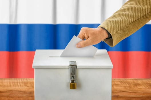 Man throws ballot papers into ballot box - Russia