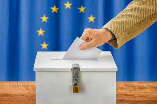 Man throws ballot papers into ballot box - European Union