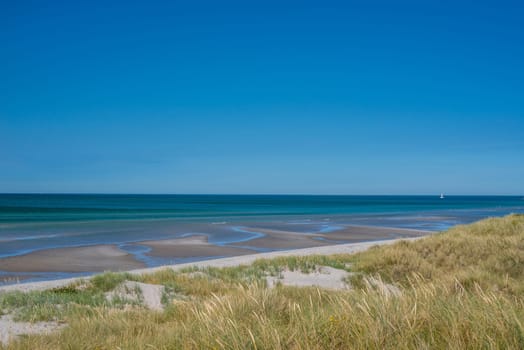 Beach with low tide water in the summer