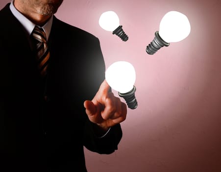 Business man pointing on a light bulb, new idea concept