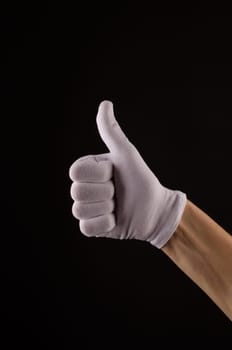 Male hand with white glove with thumb up