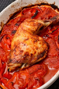 Roasted spicy chicken with tomatoes, pepper and hot chili