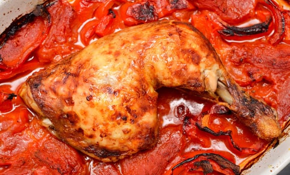 Roasted spicy chicken with tomatoes , red pepper and hot chili