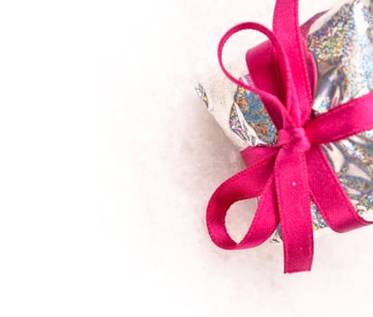 Gift box with a pink bow with space for text or image on left